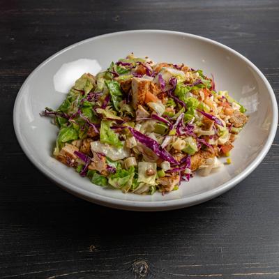 Chopped salad with chicken, cabbage, tomato and lettuce.