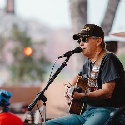 Outdoors, musician performing in front of guests