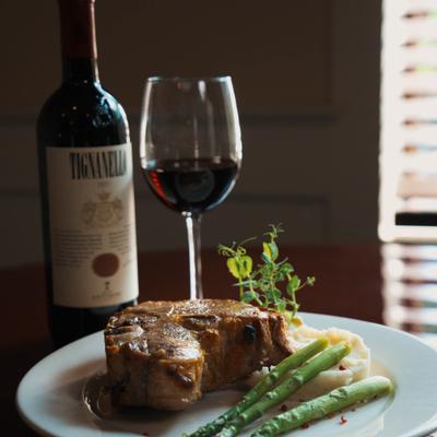 Veal chop with mashed potatoes, asparagus, and red wine.