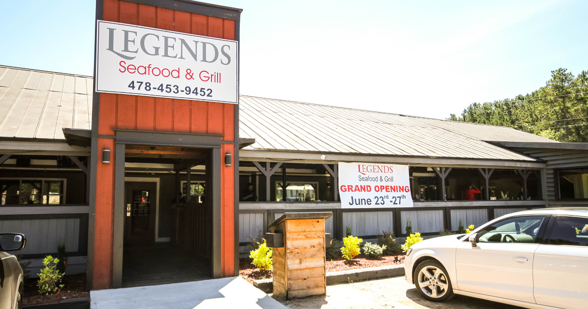 Exterior, view from the street, main entrance with a restaurant sign above it