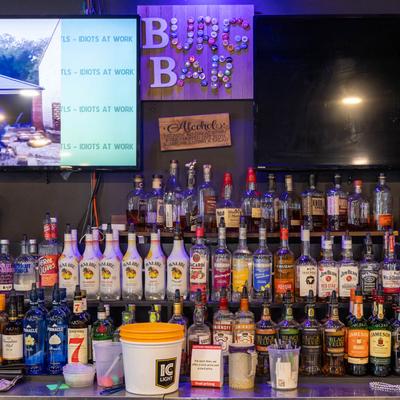 Assorted liquor bottles on the bar shelves.