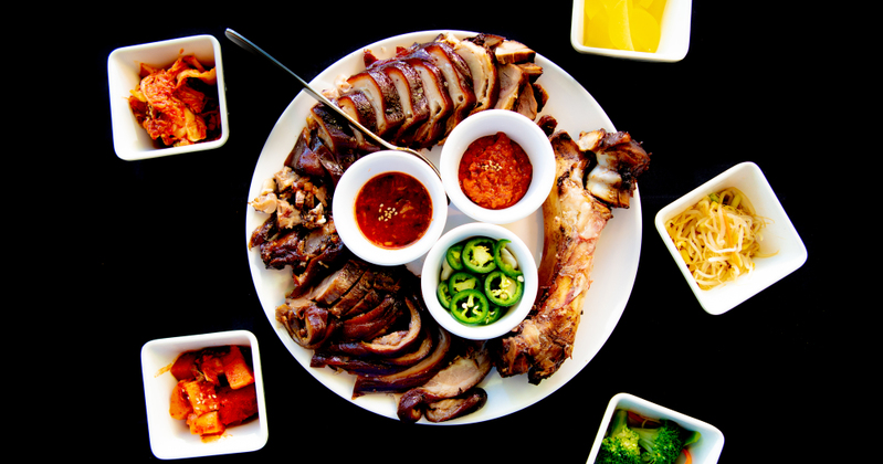 Grilled sliced meat, dips, snacks and salads