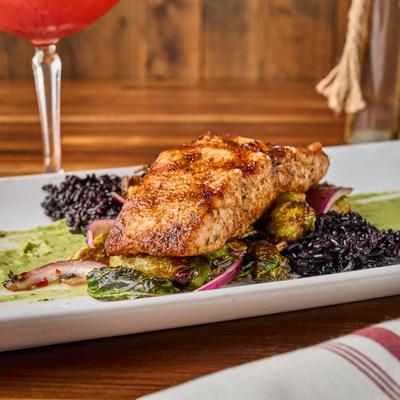 Grilled salmon, with black rice, avocado puree, and crispy brussels sprouts.