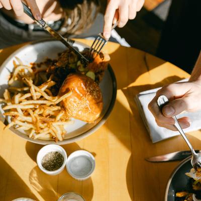 People's hands while eating.