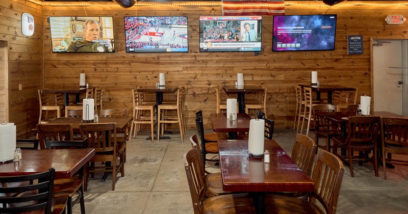Interior, seating area with four TV screens on the wall