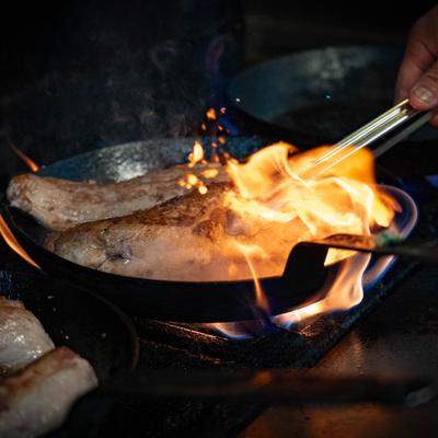 Meat being cooked in a pan.
