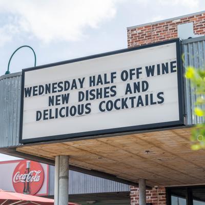 Outdoor letter board sign advertising Wednesday wine and food specials.