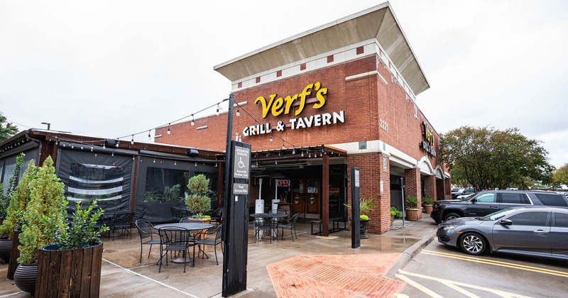 Exterior, restaurant building, parking lot, cars, plants, tables, chairs, entrance