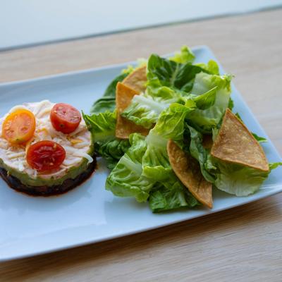 Taco salad, with lettuce, vegetarian chili, avocado, sambol sour cream, and ranch.