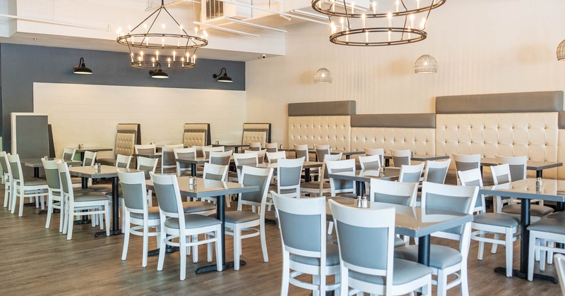 Interior, tables with chairs and booths in the back