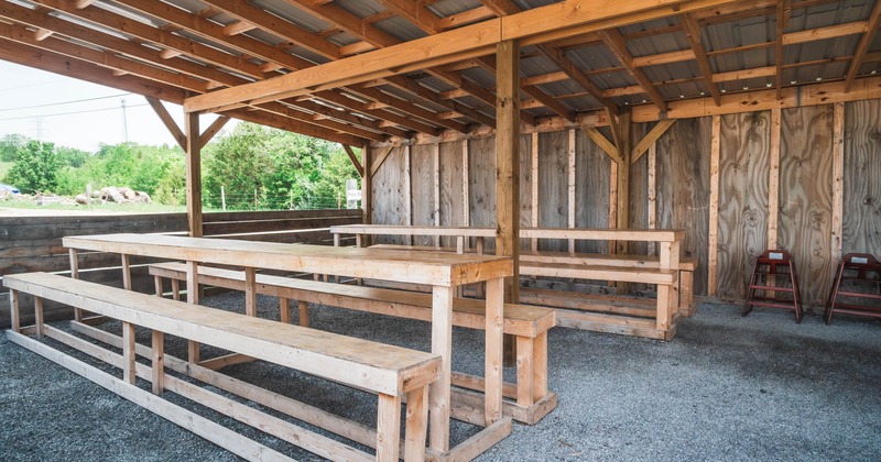 Exterior, benches and tables for eating and drinking in the covered shed