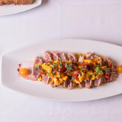 Tuna Steak with grilled lobster tail and  prawns, top view.