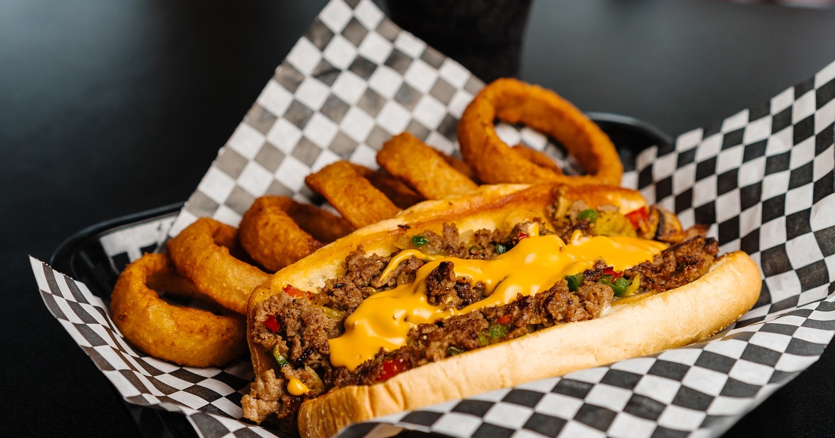 Philly cheesesteak sandwich with onion rings