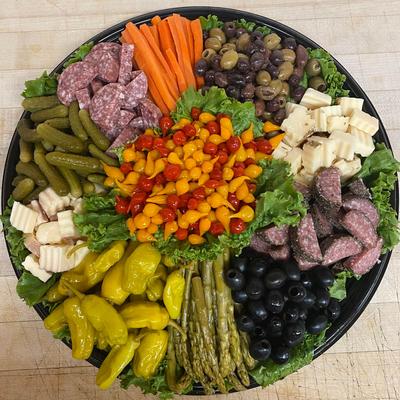 Tray with salami, sausage, assorted peppers, pickles, carrots, olives, asparagus, and cheese