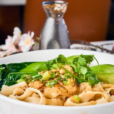 Noodles with soy sauce, vinegar, scallions, garlic, numbing sauce, and cilantro.