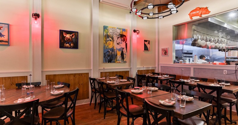 Interior area, tables, chairs, paintings on the walls