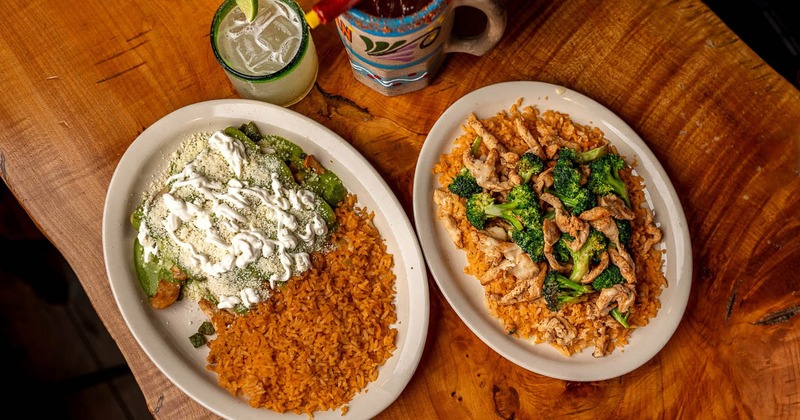 Chicken enchiladas with rice on the side, sliced chicken and broccoli on rice, drinks