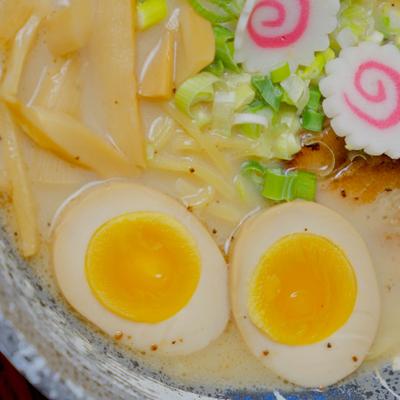 Tonkotsu Ramen with soft-boiled egg and fish cake, close-up.