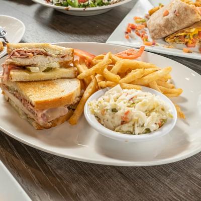 Chicken sandwich with fries and coleslaw on the side