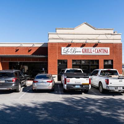 Parked cars outside of the restaurant.