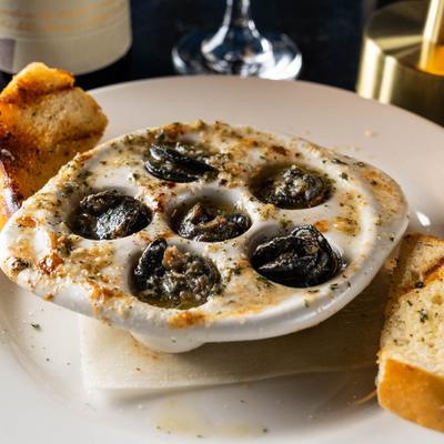 Six escargot baked in a garlic butter sauce, served with crostini bread.