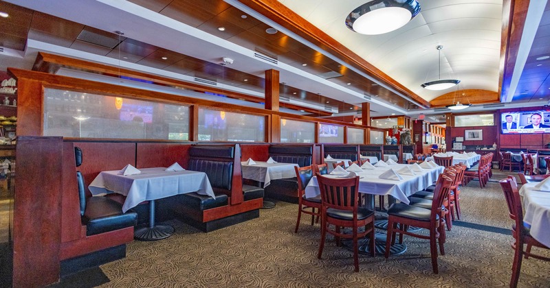 Interior of a contemporary restaurant with booth and table seating, white tablecloths