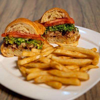 Chicken Salad Croissant, with toasted almonds, cranberries, lettuce, tomato, and fries.