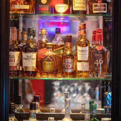 Assorted liquor bottles on a shelf.