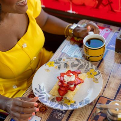 Customer having strawberry crepes and coffee.