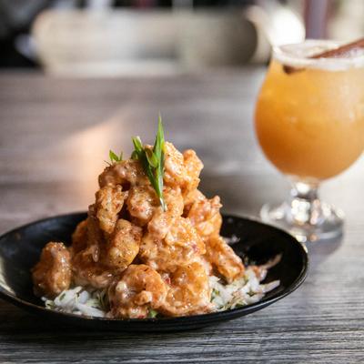 Spicy fried shrimp dish with a glass of Autumn Cider
