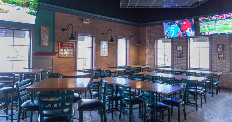 Spacious interior seating area with wooden tables and upholstered chairs