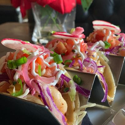 Three Shrimp Tacos with cabbage, pico de gallo, crema, pickled onion..