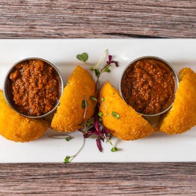 Arancini with tomato sauce.