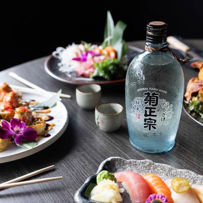 Various dishes  served on a table with sake.