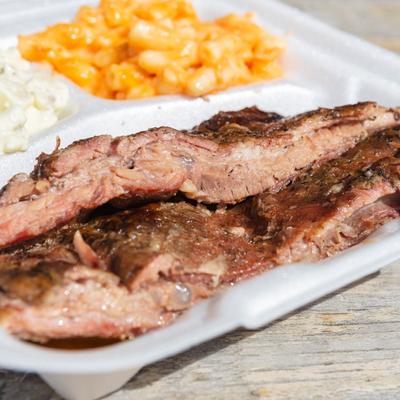 Ribs with side of mac and cheese and potato salad.