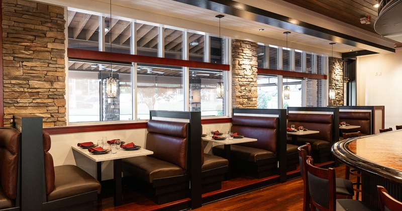 Cozy dining area with set dining booths along the windows