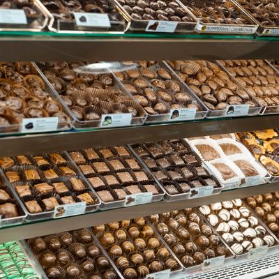 A display case filled with a variety of fresh, handmade chocolates and truffles.