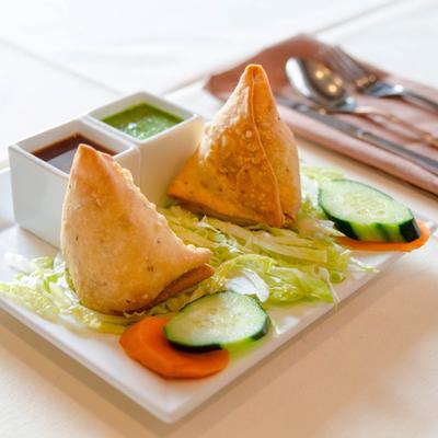 Samosa plate with house special tamarind and cilantro chutney.