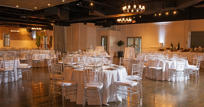 Banquet room with round tables covered with white cloths