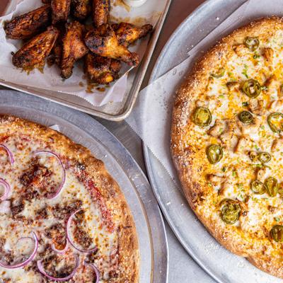 Chicken jalapeno pizza, sausage onion pizza, and grilled chicken wings