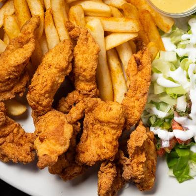 Fried chicken strips served with fries and salad.