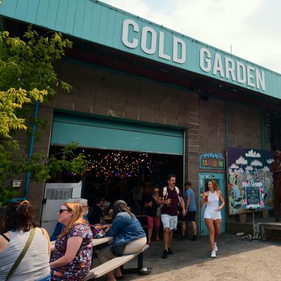 Cold Garden entrance with signage and outdoor seating.
