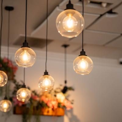 A series of modern pendant lights with exposed filament bulbs.