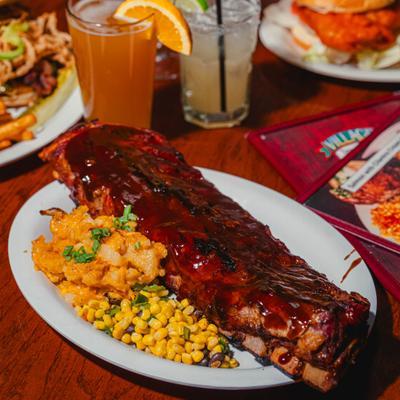 Slow Cooked Baby Back Ribs with sides of mashed potatoes and sweet corn.