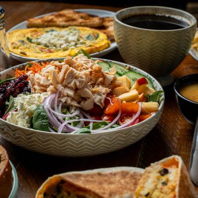 Plates and bowls with various food.