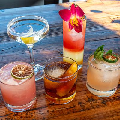 Assorted cocktails arranged on wooden table
