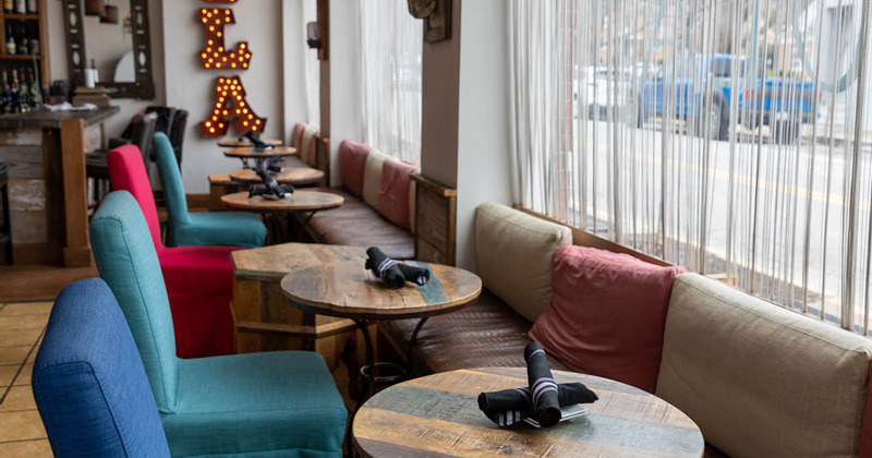 Interior, lined up tables with chairs and seats