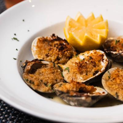 Baked littleneck clams served with lemon.