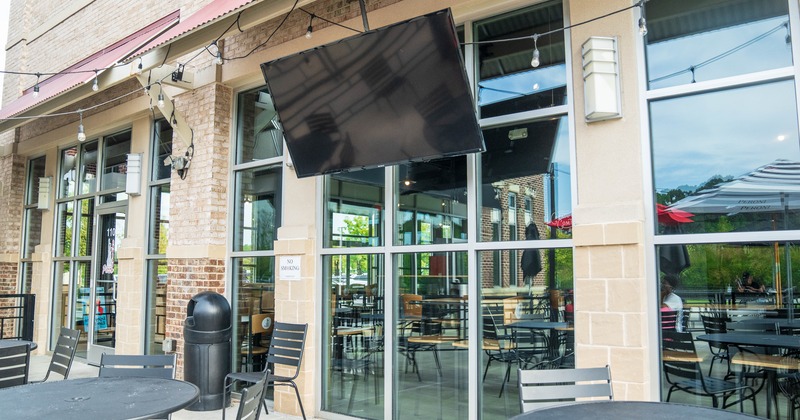 Exterior, front view, side walk patio, table and chairs