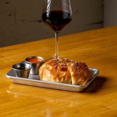 Focaccia with sea salt and rosemary accompanied by marinara, olive oil, and red wine.